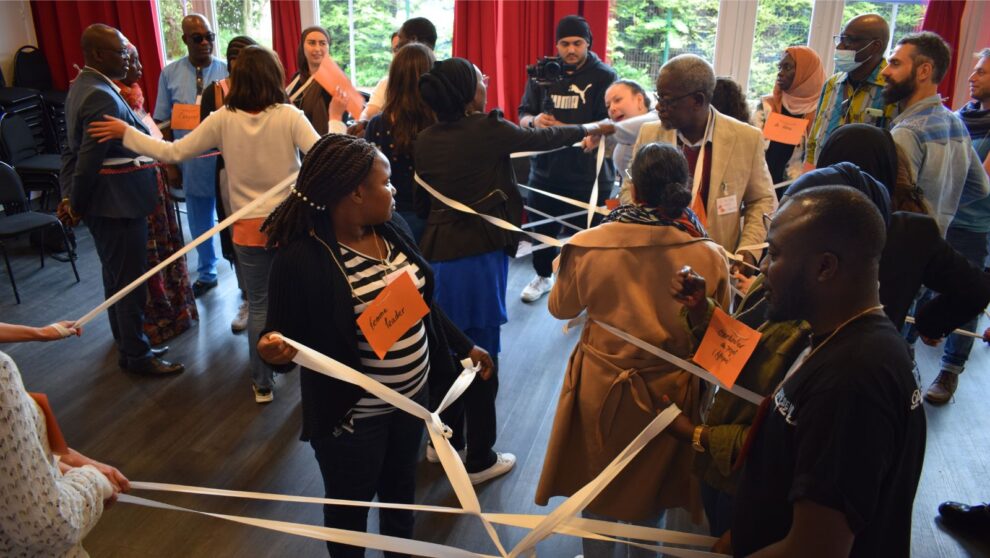 Un groupe d'adulte participe à un atelier interactif avec des rubans