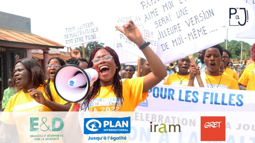 Groupe de jeunes femmes manifestant dans la rue avec haut parleur et pancartes